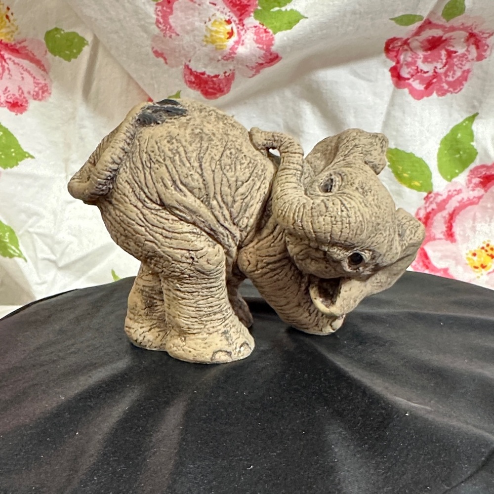 “Sniff” from The Herd Charming Brown Elephant Ceramic Sculpture